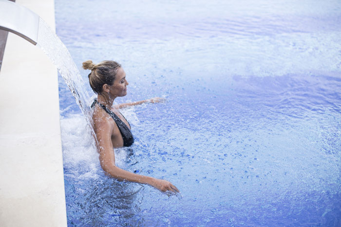 A lady in the swimming pool of Ombria Resort Spa